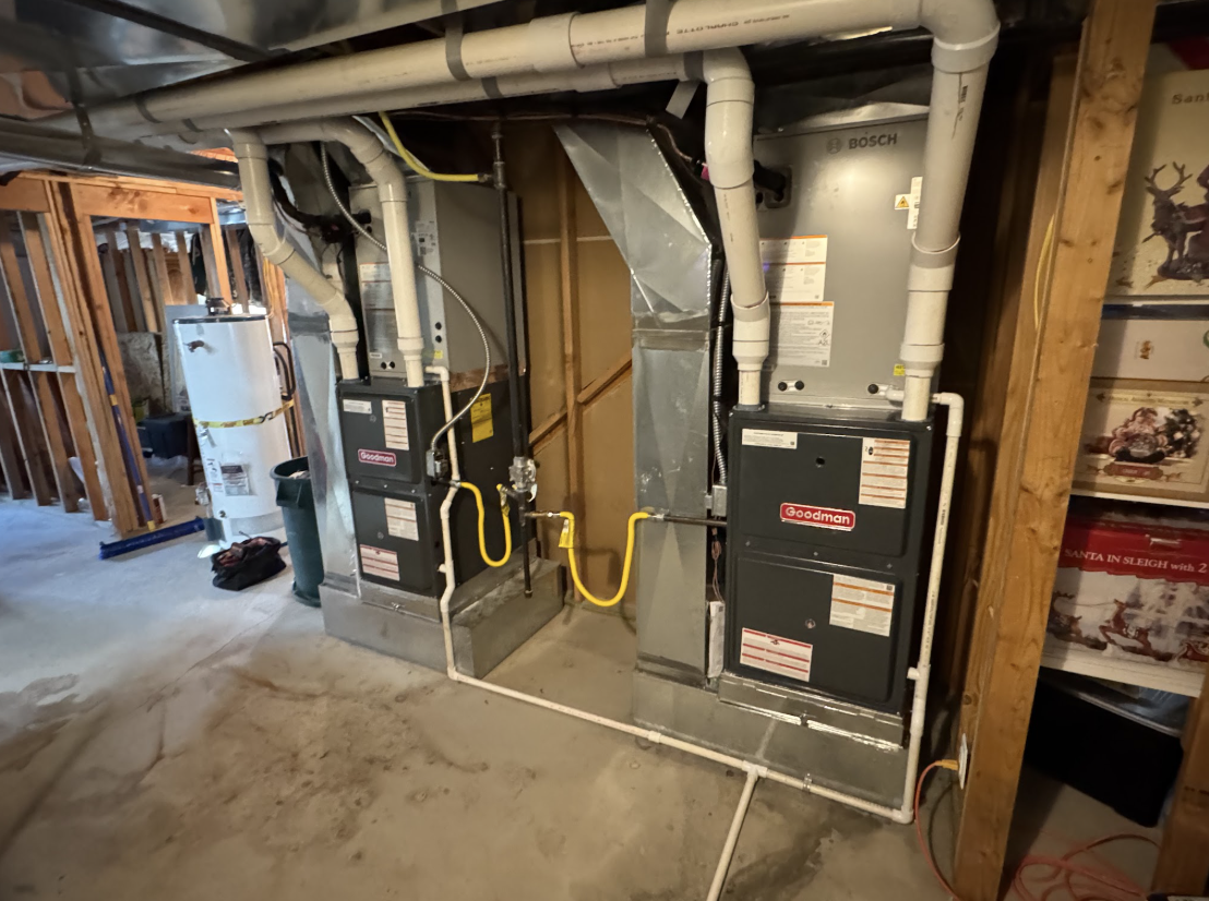 Goodman and Bosch furnace installation in a basement mechanical room
