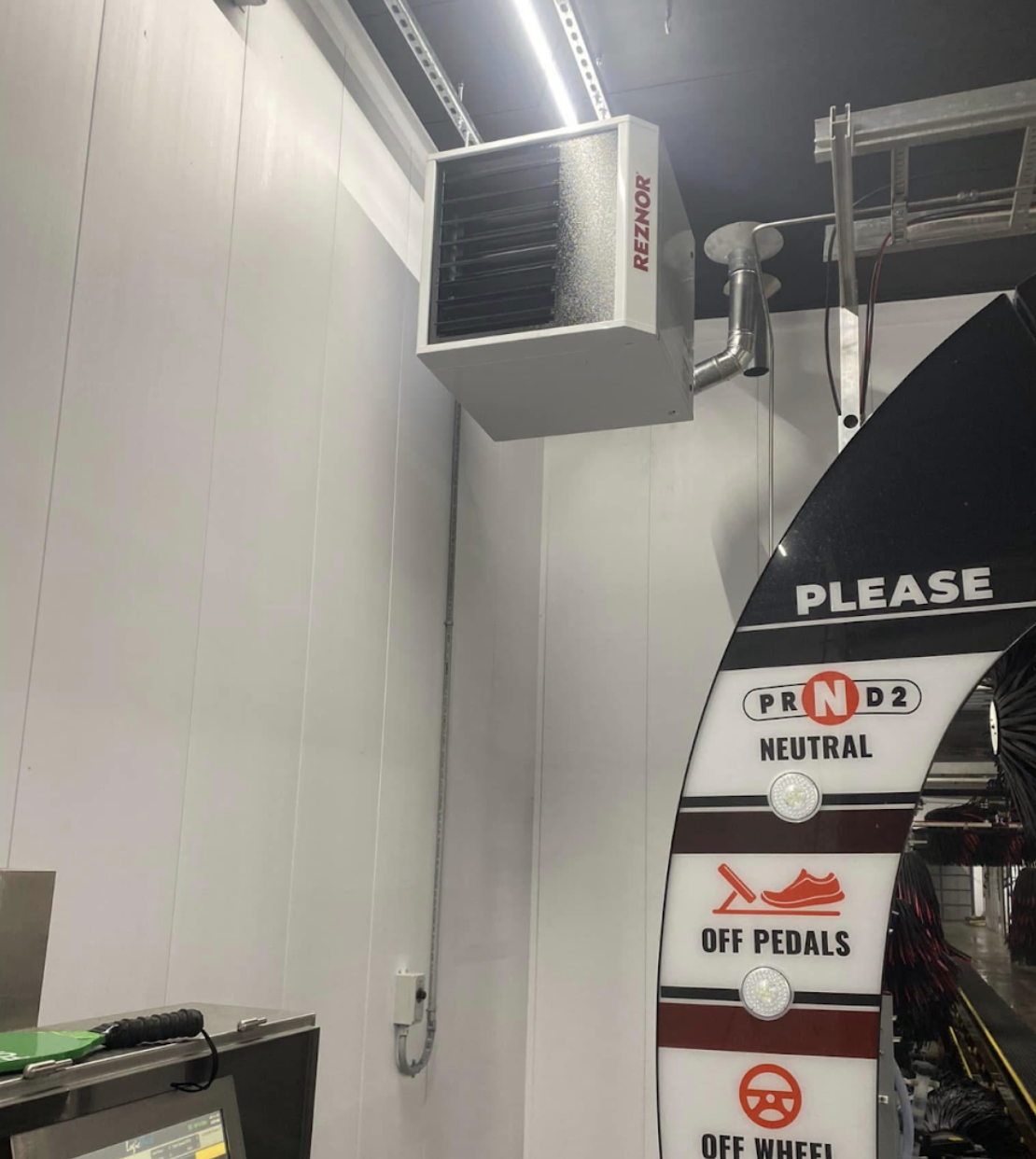 Reznor wall-mounted unit heater installed in a commercial car wash