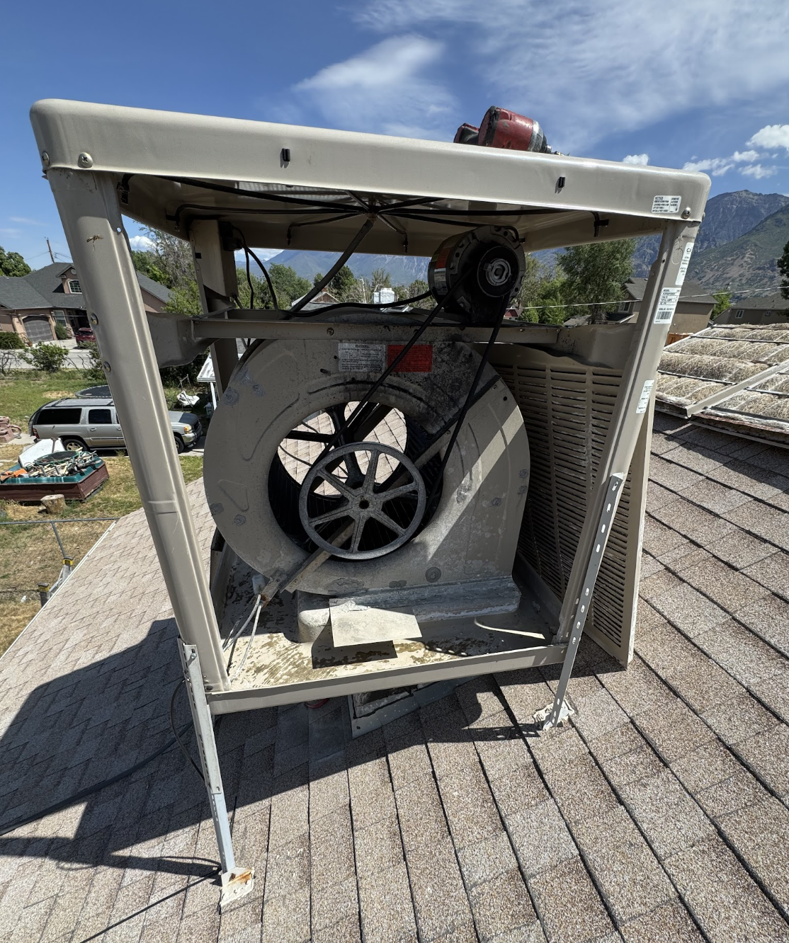 Swamp cooler blower, motor, and belt assembly during maintenance