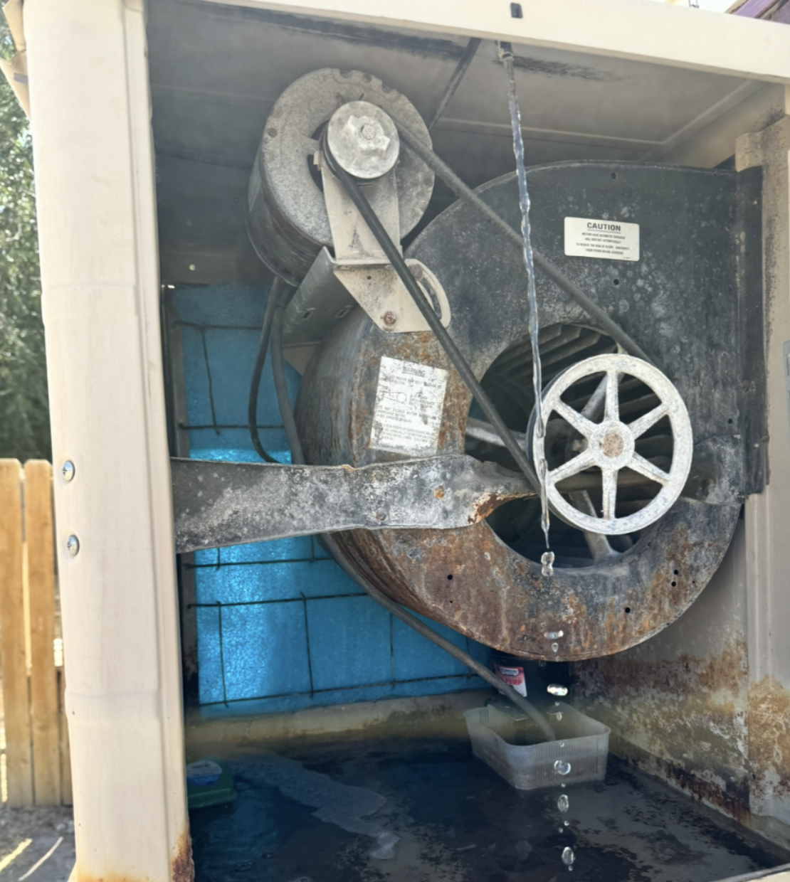 Evaporative cooler repair in progress on a residential roof